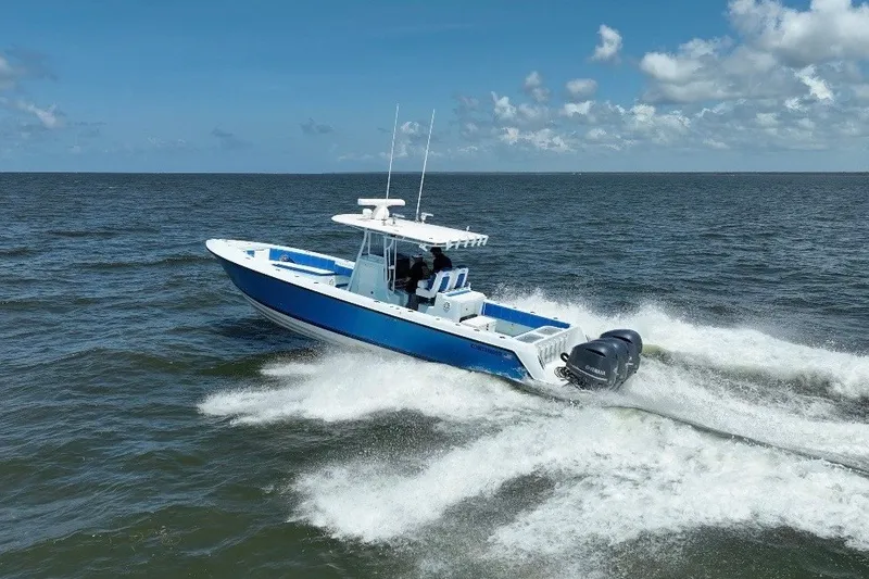 Slide: The Image of 2012 Contender 35 ST boat cruising on open water under a clear blue sky. - 30