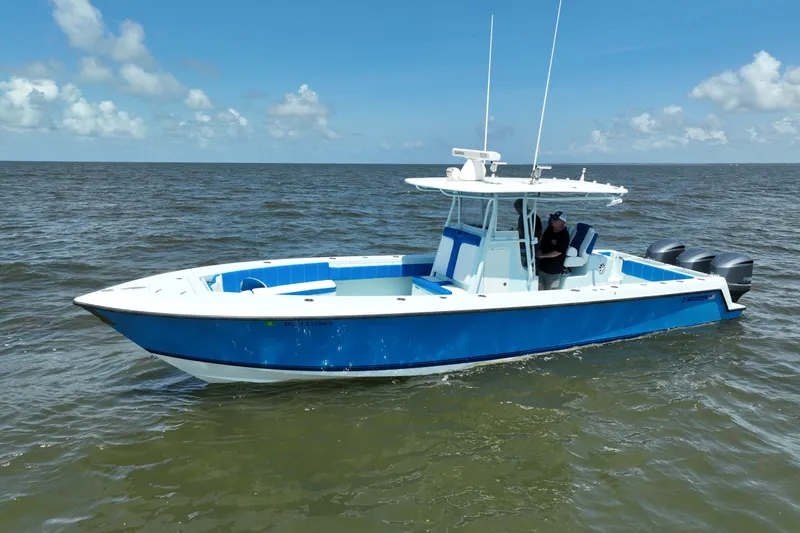 Slide: The Image of 2012 Contender 35 ST boat on open water, featuring a sleek blue and white design. - 2