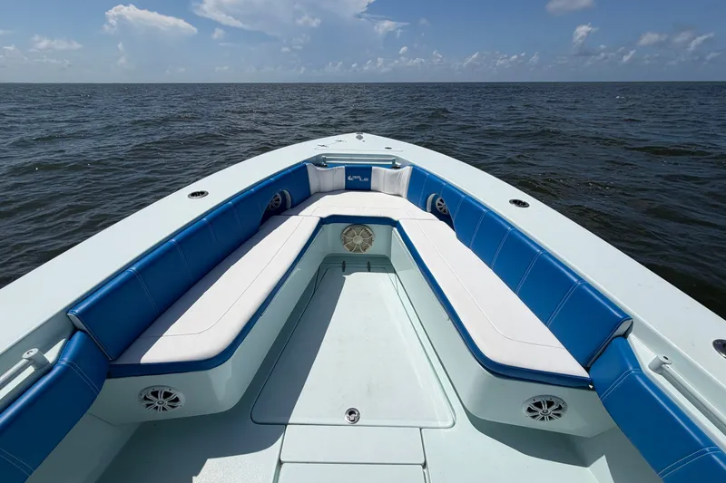 Slide: The Image of 2012 Contender 35 ST boat with blue and white seating on open water. - 14