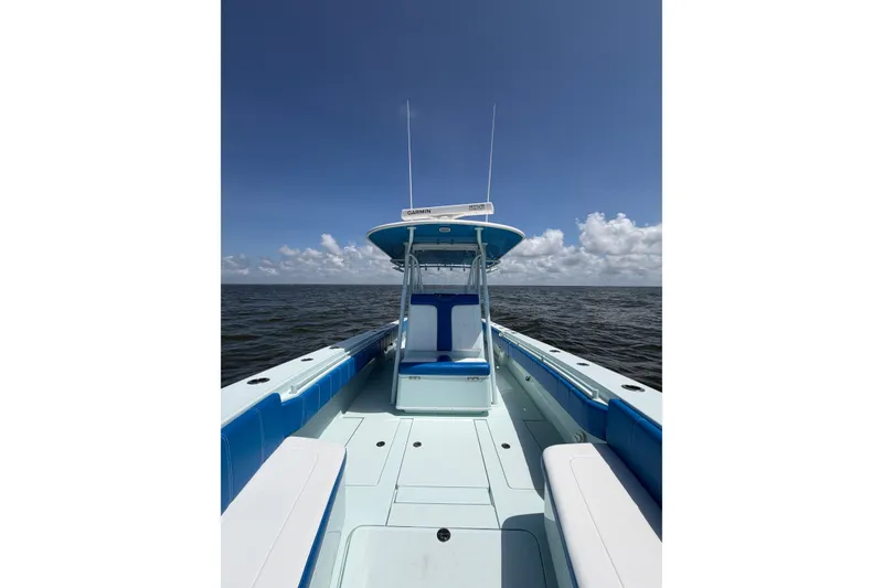Slide: The Image of 2012 Contender 35 ST boat on open water under clear blue sky. - 15