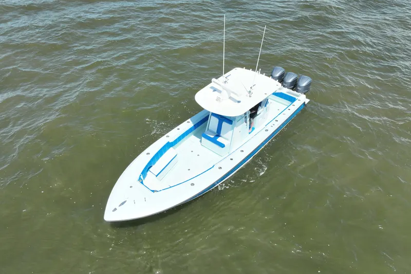 Slide: The Image of 2012 Contender 35 ST boat with triple engines on open water. - 11