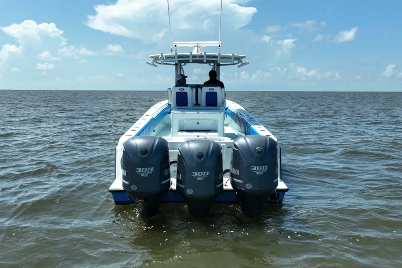 Slide: The Image of 2012 Contender 35 ST boat with triple Yamaha 300 engines on open water. - 6
