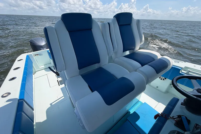 Slide: The Image of 2012 Contender 35 ST boat with blue and white seating on open water. - 25