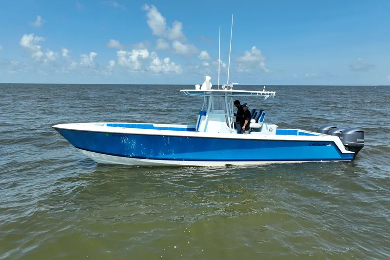 Slide: The Image of 2012 Contender 35 ST boat on open water under clear blue sky. - 3