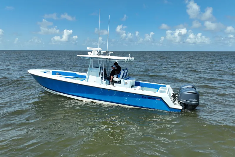 Slide: The Image of 2012 Contender 35 ST boat on open water, featuring dual Yamaha engines. - 4