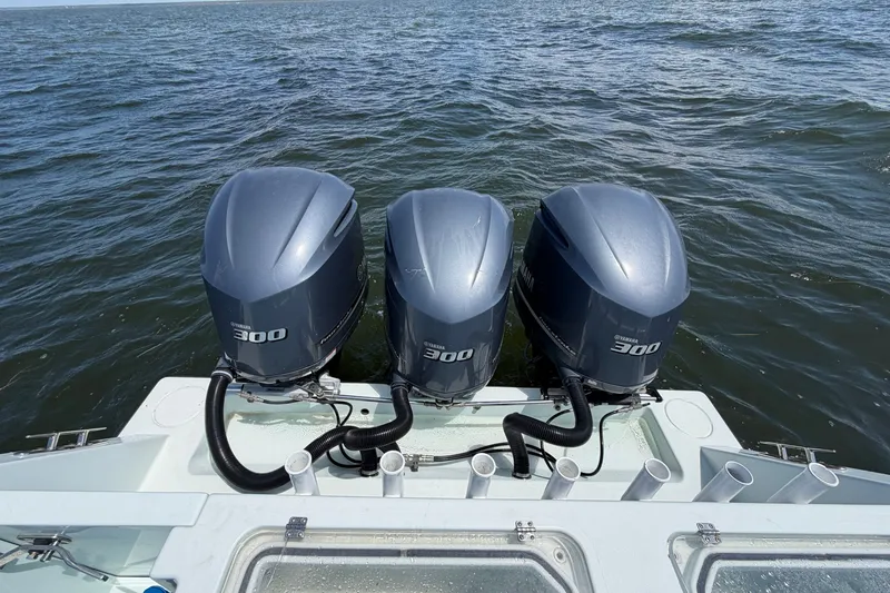 Slide: The Image of 2012 Contender 35 ST boat with triple Yamaha 300 outboard engines on open water. - 18