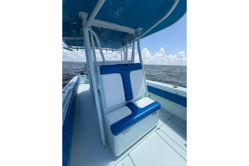 Slide: The Image of 2012 Contender 35 ST boat with blue and white seating on open water. - 16