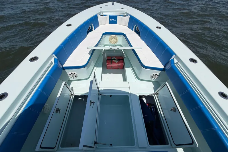Slide: The Image of 2012 Contender 35 ST boat interior with blue seating and open storage compartments. - 26