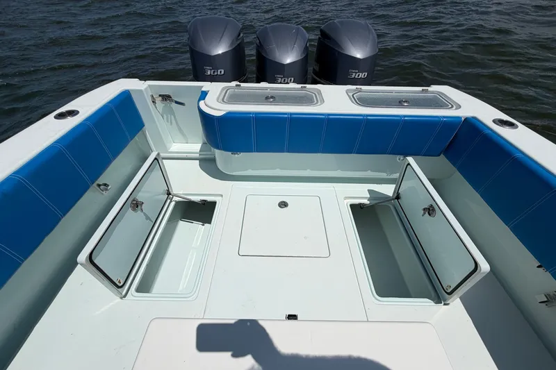 Slide: The Image of 2012 Contender 35 ST boat deck with storage compartments and triple 300 engines. - 28