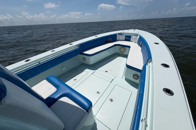Slide: The Image of 2012 Contender 35 ST boat interior with blue and white seating on open water. - 13