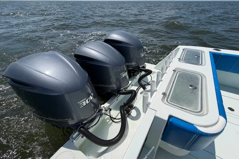 Slide: The Image of 2012 Contender 35 ST boat with triple Yamaha 300 engines on open water. - 19