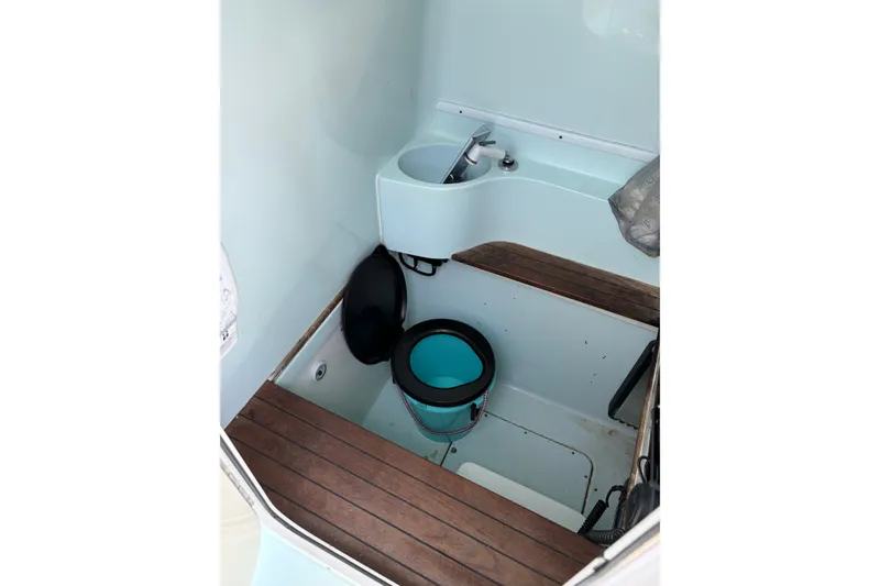 Slide: The Image of Interior of 2012 Contender 35 ST boat with compact sink and wooden flooring. - 29