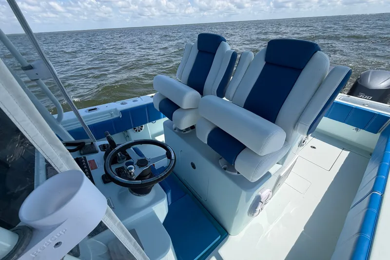 Slide: The Image of 2012 Contender 35 ST boat interior with dual blue and white captain seats. - 22
