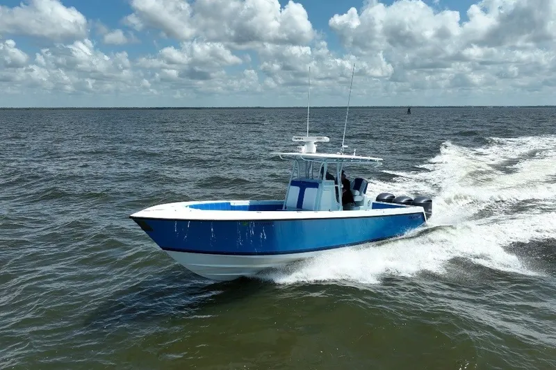 Slide: The Image of 2012 Contender 35 ST boat cruising on open water under a partly cloudy sky. - 0