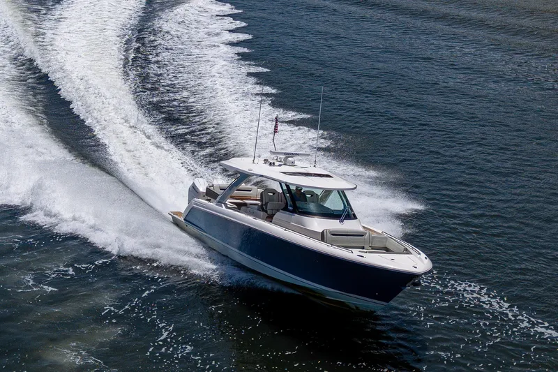 Slide: The Image of 2024 Tiara Yachts 38 LS cruising on open water, showcasing sleek design and performance. - 12