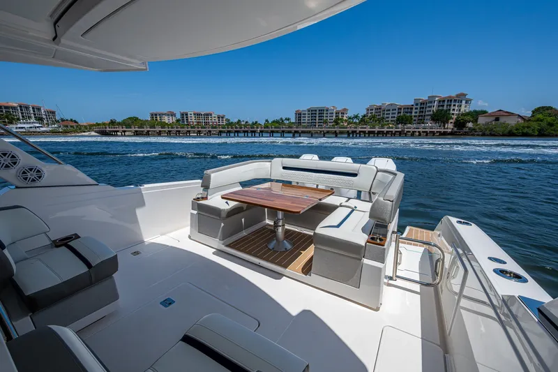 Slide: The Image of Luxurious 2024 Tiara Yachts 38 LS with elegant seating and scenic waterfront view. - 23