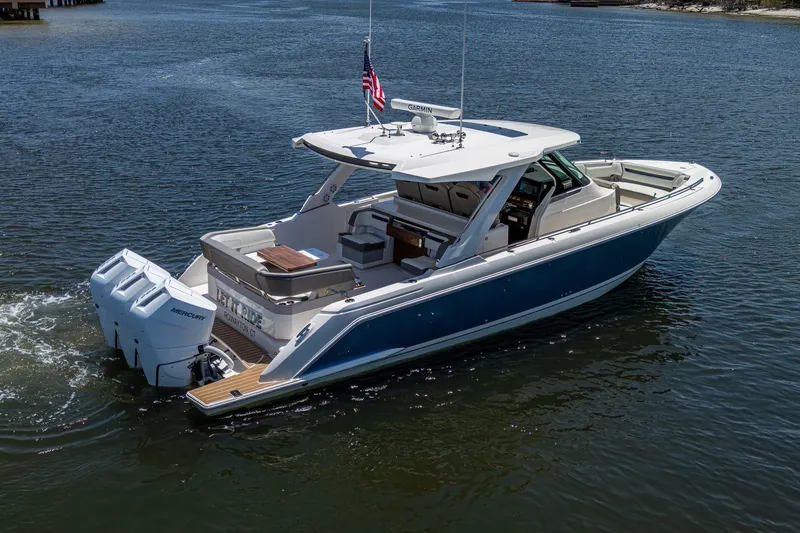 Slide: The Image of 2024 Tiara Yachts 38 LS cruising on water, featuring sleek design and powerful engines. - 7