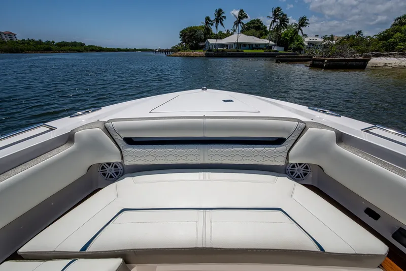 Slide: The Image of Luxurious seating on the 2024 Tiara Yachts 38 LS, overlooking serene waters and lush greenery. - 17