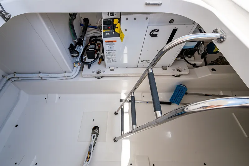 Slide: The Image of Engine compartment of 2024 Tiara Yachts 38 LS, featuring Cummins Onan generator and ladder access. - 36
