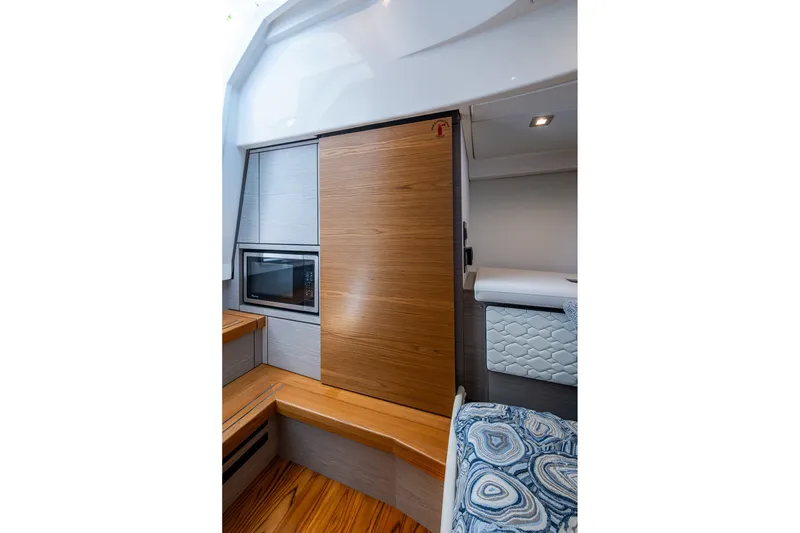 Slide: The Image of 2024 Tiara Yachts 38 LS interior with wood accents and modern amenities. - 48