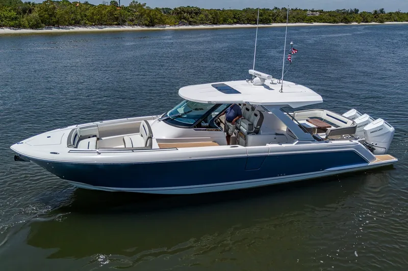 Slide: The Image of 2024 Tiara Yachts 38 LS luxury boat on calm water, showcasing sleek design and modern features. - 1
