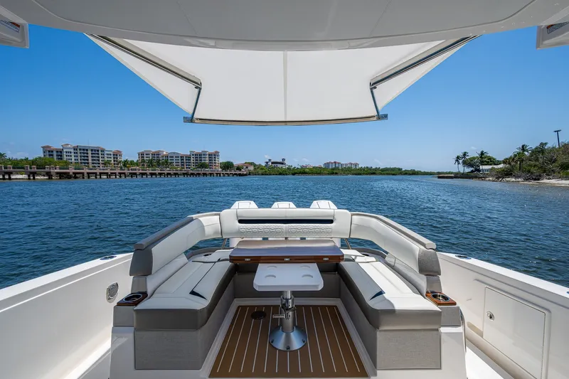 Slide: The Image of 2024 Tiara Yachts 38 LS luxury boat interior with waterfront view and seating area. - 34
