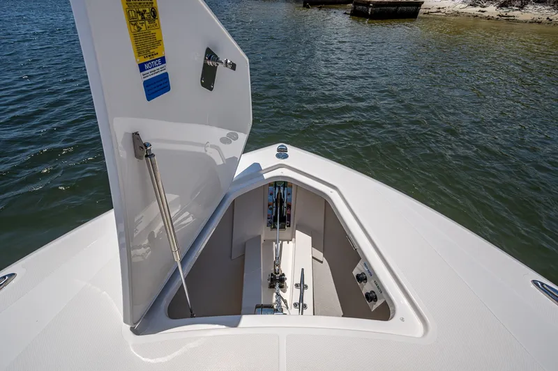 Slide: The Image of 2024 Tiara Yachts 38 LS bow storage compartment open on calm water. - 18