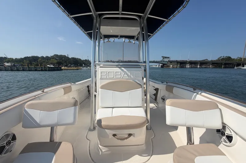 Slide: The Image of 2018 Robalo R222 Center Console boat on water, featuring spacious seating and sleek design. - 19