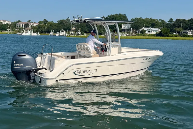 Slide: The Image of 2018 Robalo R222 Center Console boat cruising on a scenic waterway. - 8