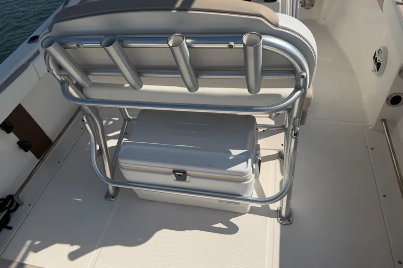 Slide: The Image of 2018 Robalo R222 Center Console boat with rod holders and cooler storage. - 27