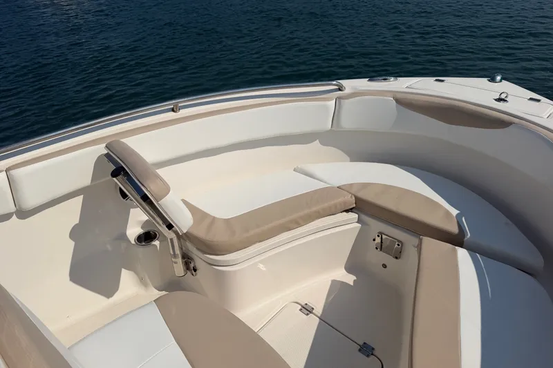Slide: The Image of 2018 Robalo R222 Center Console boat interior with cushioned seating and ocean view. - 16