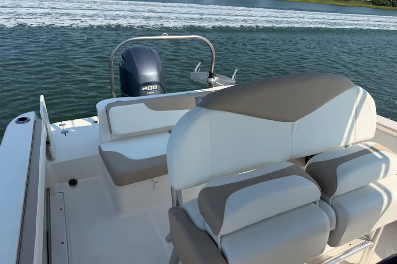 Slide: The Image of 2018 Robalo R222 Center Console boat interior with Yamaha 200 engine on water. - 33