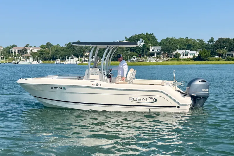 Slide: The Image of 2018 Robalo R222 Center Console boat cruising on a scenic waterway. - 11