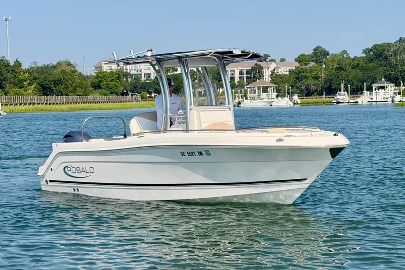 Slide: The Image of 2018 Robalo R222 Center Console boat cruising on a scenic waterway. - 4