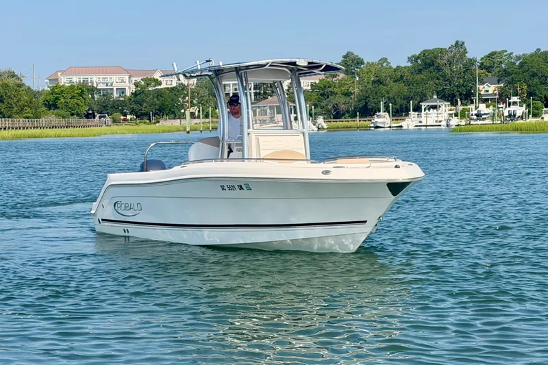 Slide: The Image of 2018 Robalo R222 Center Console boat cruising on a scenic waterway. - 3