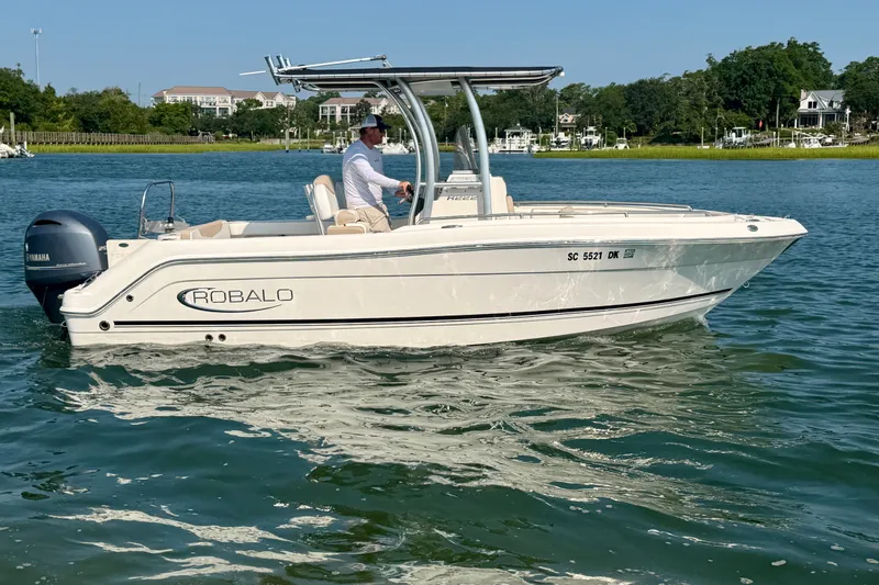 Slide: The Image of 2018 Robalo R222 Center Console boat on water, featuring Yamaha engine, scenic background. - 6