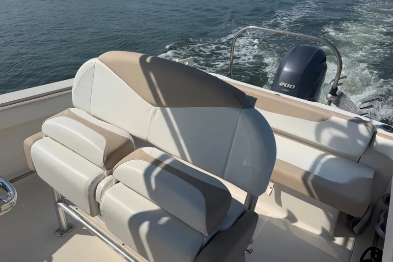Slide: The Image of 2018 Robalo R222 Center Console boat interior with cushioned seating and Yamaha 200 engine. - 31