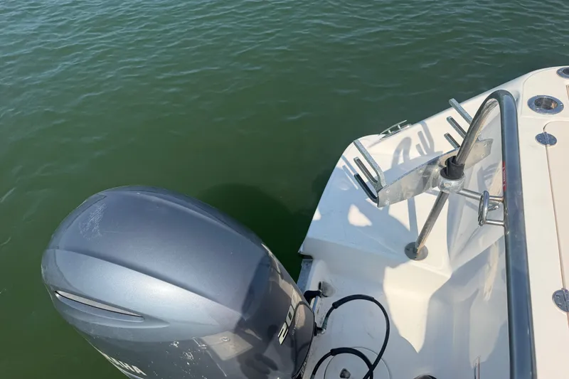 Slide: The Image of 2018 Robalo R222 Center Console boat with outboard motor on calm water. - 25