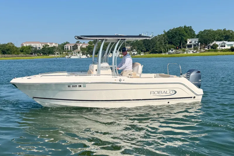 Slide: The Image of 2018 Robalo R222 Center Console boat cruising on a scenic waterway. - 12
