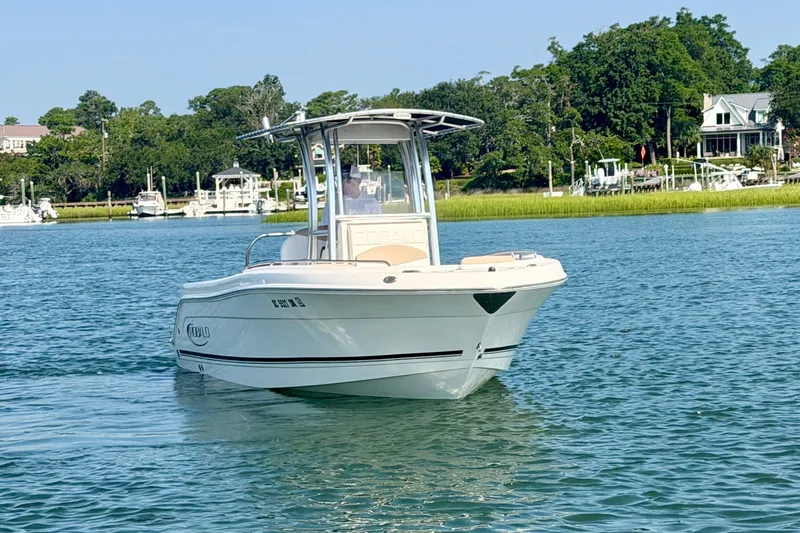 Slide: The Image of 2018 Robalo R222 Center Console boat cruising on a scenic waterway. - 2