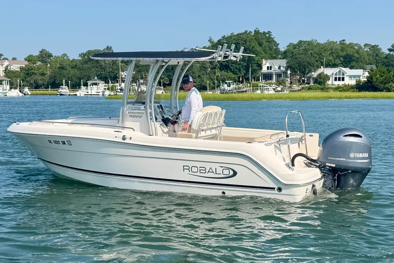 Slide: The Image of 2018 Robalo R222 Center Console boat cruising on a scenic waterway. - 10