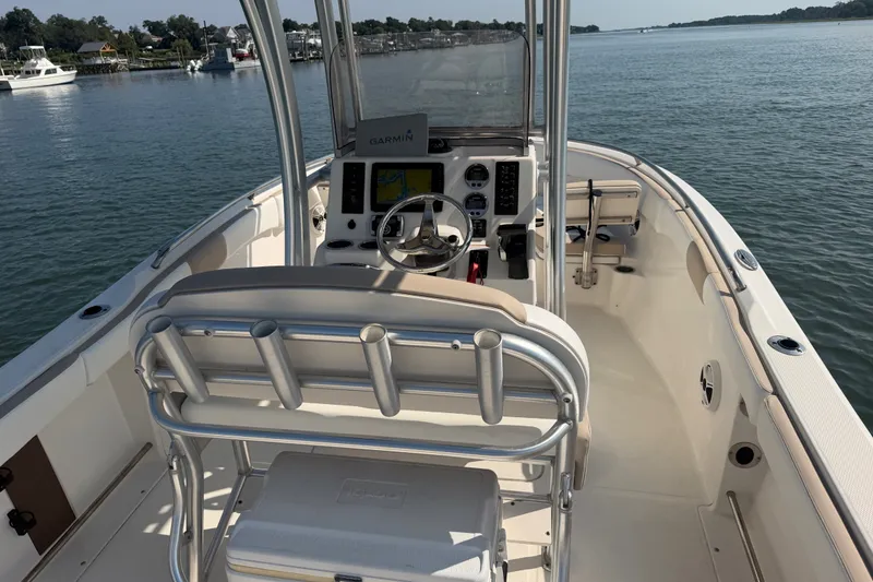 Slide: The Image of 2018 Robalo R222 Center Console boat interior with Garmin navigation on calm water. - 26