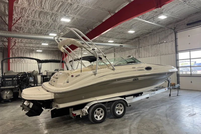 Slide: The Image of 2008 Sea Ray 240 Sundeck boat on trailer in indoor storage facility. - 4