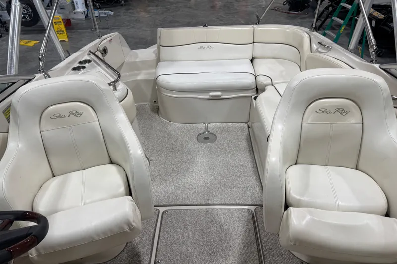 Slide: The Image of 2008 Sea Ray 240 Sundeck interior with white leather seating and spacious layout. - 5