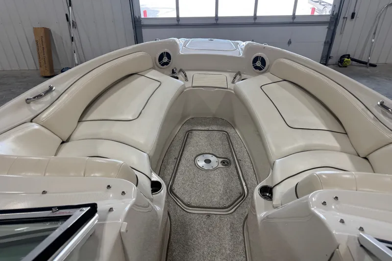 Slide: The Image of Interior of a 2008 Sea Ray 240 Sundeck boat with beige seating and carpeted floor. - 6