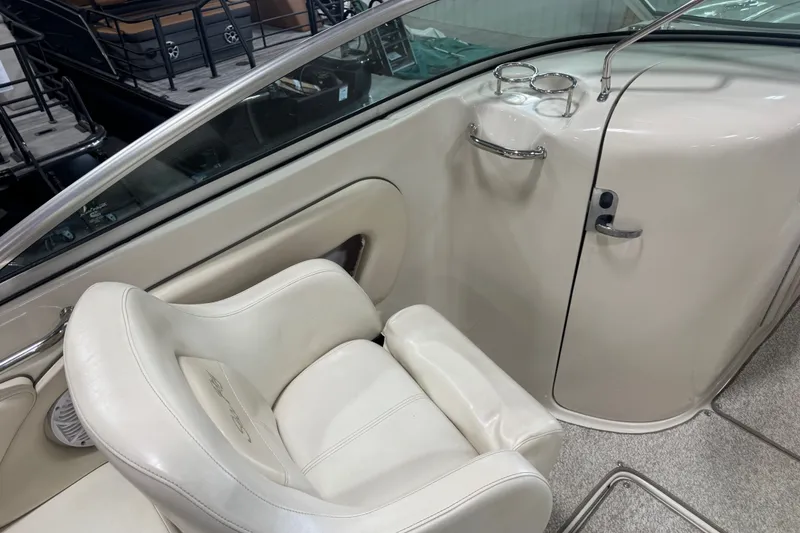 Slide: The Image of 2008 Sea Ray 240 Sundeck interior with white seating and cup holders. - 7
