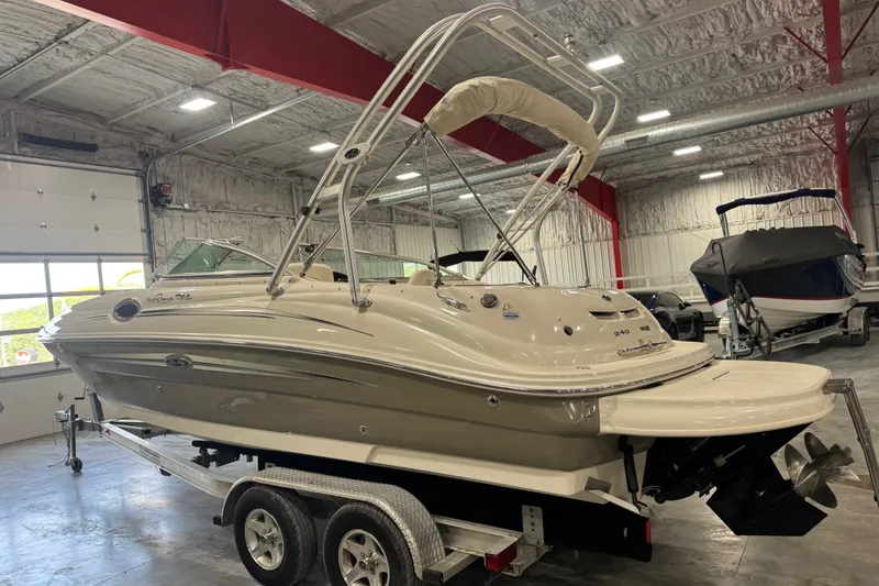 Slide: The Image of 2008 Sea Ray 240 Sundeck boat on trailer in indoor storage facility. - 3
