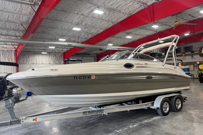 Slide: The Image of 2008 Sea Ray 240 Sundeck boat on trailer in indoor storage facility. - 2