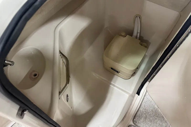 Slide: The Image of Interior of 2008 Sea Ray 240 Sundeck boat with compact toilet and sink. - 9