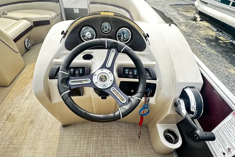 Slide: The Image of Steering console of a 2018 Berkshire Pontoon boat with gauges and controls. - 6